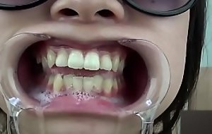 A woman shows the brush gums added to sputs saliva