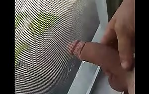 Jerking by window while cars pass by