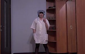 A nurse in stockings stretches a hairy pussy with a medical gynecological expander. Gaping hole and clitoris close-up. Masturbation during a break at work.