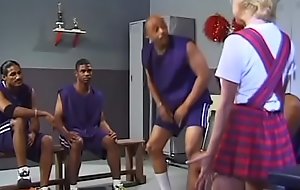 A young slut in a short dress serves the black guys' basketball team in the locker room after the game