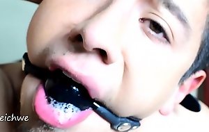 Very tight gag in the mouth with saliva