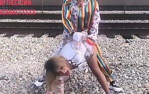Clown fucks girl on train tracks