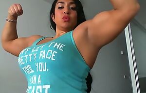 Spunky female bodybuilder proudly shows her muscles