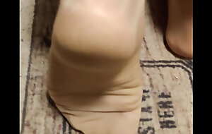 different footplay in tan nylons