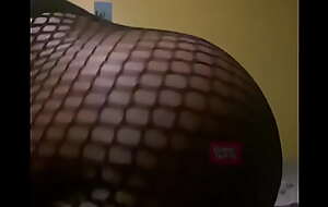 Shaking ass in fishnet body suit